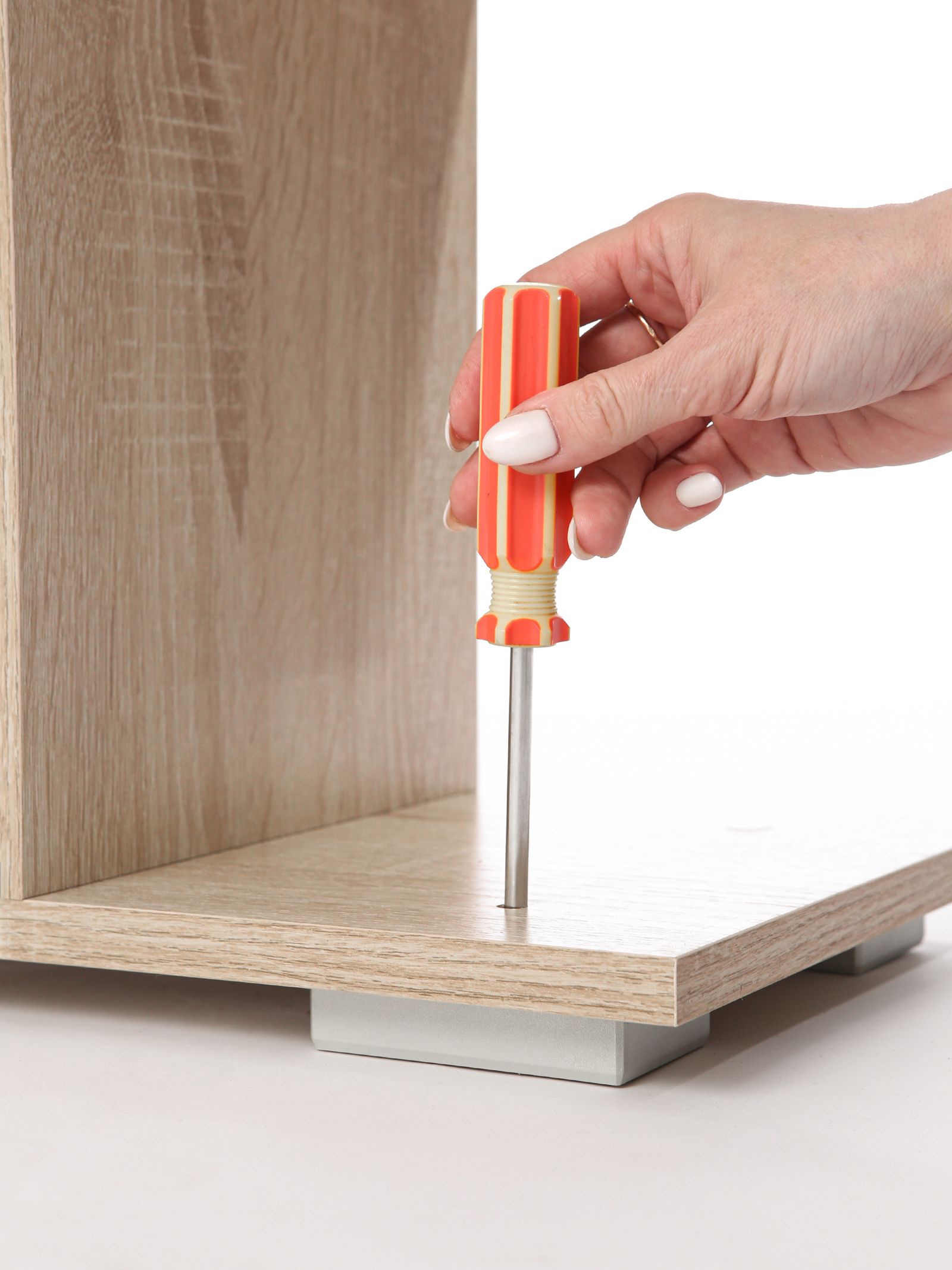 Furniture being assembled with a screwdriver