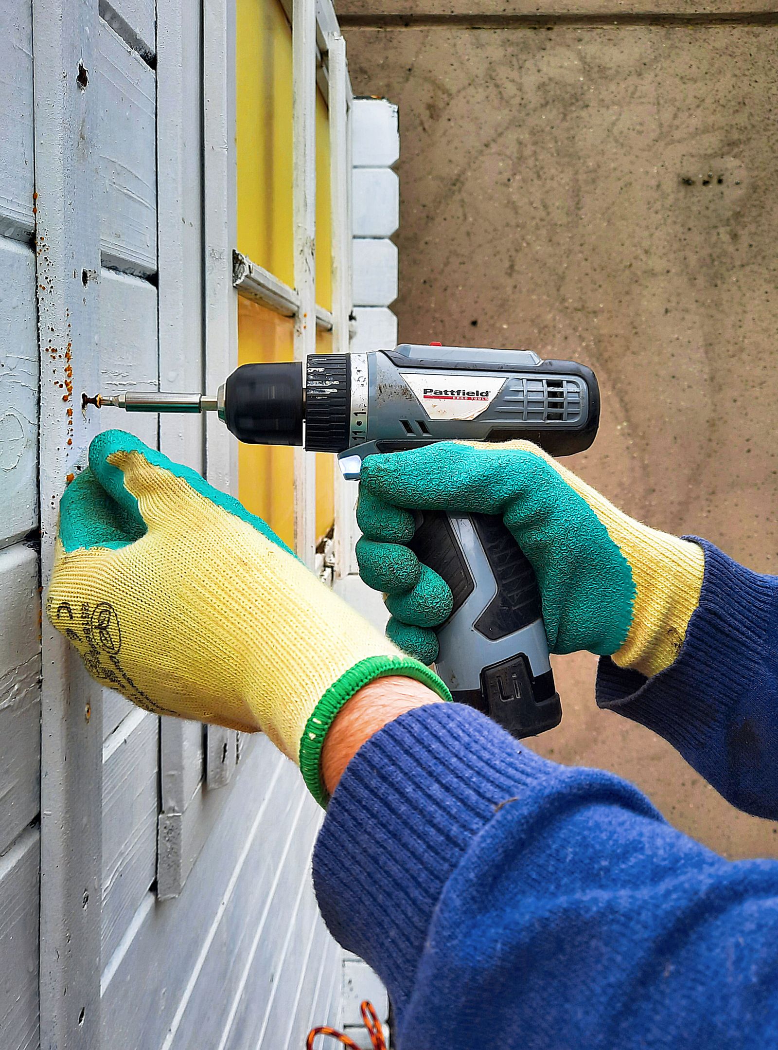 Handyman repairing an exterior wooden frame